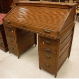 An early 20th Century oak tambour top desk,