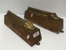 A pair of Victorian brass folding shelf wall brackets, inscribed "SP" to base, on oak mounts, 30.