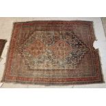 A Bokhara rug, the central panel set with repeating medallions on a rust ground,