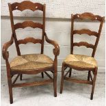 A set of eight French stained beech ladder back rush seat dining chairs in the 19th Century manner