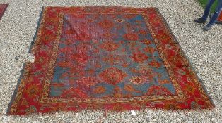 A Turkish rug, the central panel set with repeating design on a blue ground, within a stepped blue,