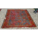 A Turkish rug, the central panel set with repeating design on a blue ground, within a stepped blue,