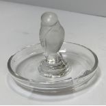 A Lalique pin dish with central bird decoration.