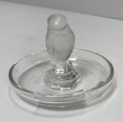 A Lalique pin dish with central bird decoration.