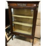 A 19th Century Continental mahogany display cabinet in the Empire taste with brass embellishments