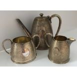 A plated tea service comprising teapot,