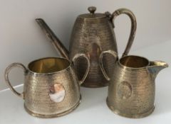 A plated tea service comprising teapot,