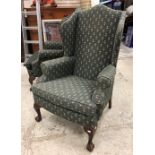 A pair of early to mid 20th Century wing back scroll arm chairs on cabriole front legs to claw and