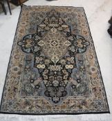 A Persian design rug with centre medallion on a blue black ground,