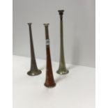 Three metal hunting horns of various sizes