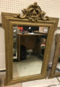 Two French Henry V style giltwood and gesso framed wall mirrors with scrollwork decorated surmounts,