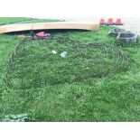 A wrought iron pond cover of domed gridded form,