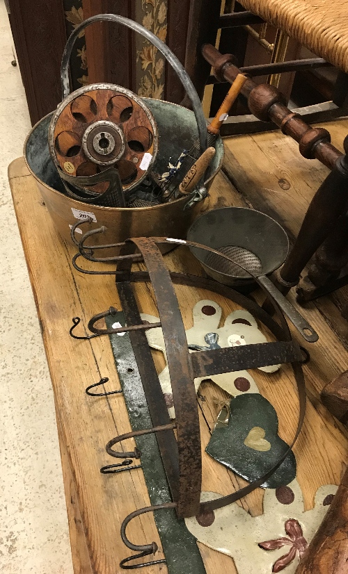 A collection of items including a brass jam pan, an egg holder and timer repurposed from a bobbin,