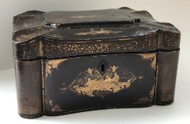 A 19th Century black lacquered and chinoiserie decorated tea caddy of shaped rectangular form,