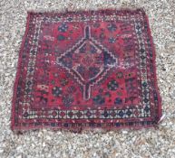 A Shiraz cushion, approx 116 cm, together with a rug,