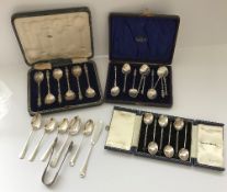 A cased set of six silver coffee bean spoons, a cased set of six silver Apostle spoons,