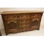 A 19th Century North Country oak and inlaid enclosed dresser,