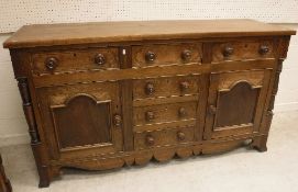 A 19th Century North Country oak and inlaid enclosed dresser,