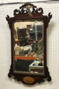 A mahogany and carved giltwood fretwork decorated wall mirror in the Georgian style with bevel