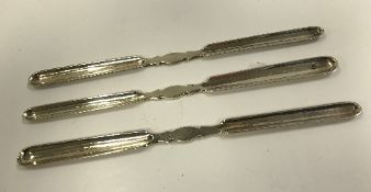A set of three Edwardian silver double-ended marrow scoops (by Mappin & Webb,