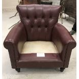A modern buttoned leather upholstered scroll armchair of squat proportions,