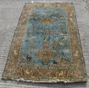 A Tree of Life style Persian rug decorated with foliage, birds,