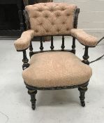 A Victorian ebonised and gilt decorated button back salon armchair with upholstered arms and seat