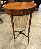A 19th Century mahogany and inlaid Sheraton Revival sewing table of oval form with single drawer