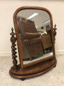 A late Victorian buttoned upholstered salon armchair on turned front legs,