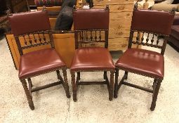 A set of three French oak framed dining chairs in the 17th Century style with leather upholstered