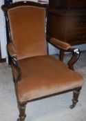 A Victorian rosewood framed upholstered open arm elbow chair with shepherd's crook arms,