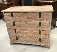 A 19th Century Continental pitch pine commode of four long drawers with aesthetic style brass drop