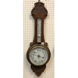 A circa 1900 carved oak cased barometer thermometer,