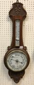 A circa 1900 carved oak cased barometer thermometer,