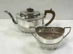 A late Victorian silver teapot of half reeded decoration (by Harrison Brothers and Howson,