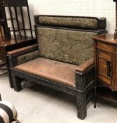An unusual Victorian oak and inlaid settle with upholstered back panels and blind fretwork carved
