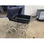 A Silver Cross pram on chrome plated supports and spoke wheels,