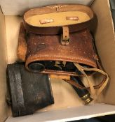 A pair of leather clad binoculars or opera glasses,