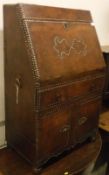 A studded brown leather covered bureau in the Spanish or Portugese taste,