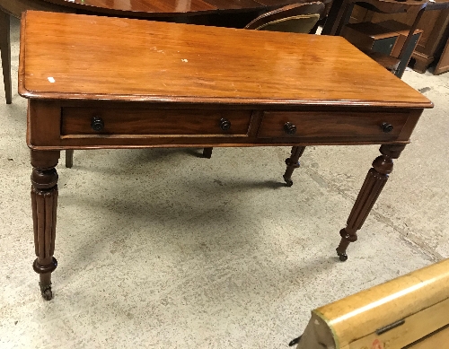 A Victorian mahogany two drawer side table on turned and reeded legs to castors,