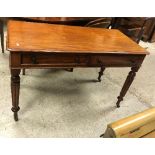 A Victorian mahogany two drawer side table on turned and reeded legs to castors,