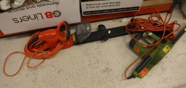 A collection of electric garden tools to include rotivator, chainsaw, hedge trimmer,