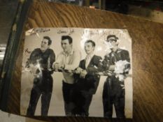 An unframed black and white photograph of The Shadows signed by all four members,