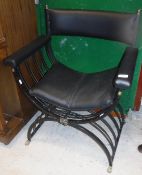 A mid 20th Century black painted wrought iron X framed chair with upholstered back panel,