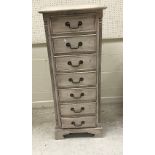 A modern grey painted chest of seven drawers, 51 cm wide x 44 cm deep x 128.