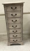 A modern grey painted chest of seven drawers, 51 cm wide x 44 cm deep x 128.