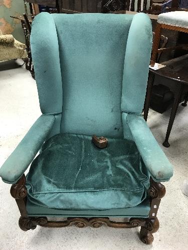 A circa 1900 upholstered wing back scroll armchair in the Flemish taste,