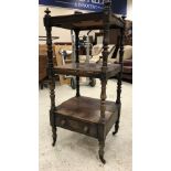 A Victorian rosewood and simulated rosewood three tier whatnot on baluster turned and ringed