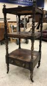 A Victorian rosewood and simulated rosewood three tier whatnot on baluster turned and ringed