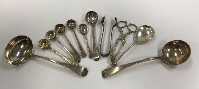 A collection of various Georgian and later silver sauce ladles, mustard spoons,